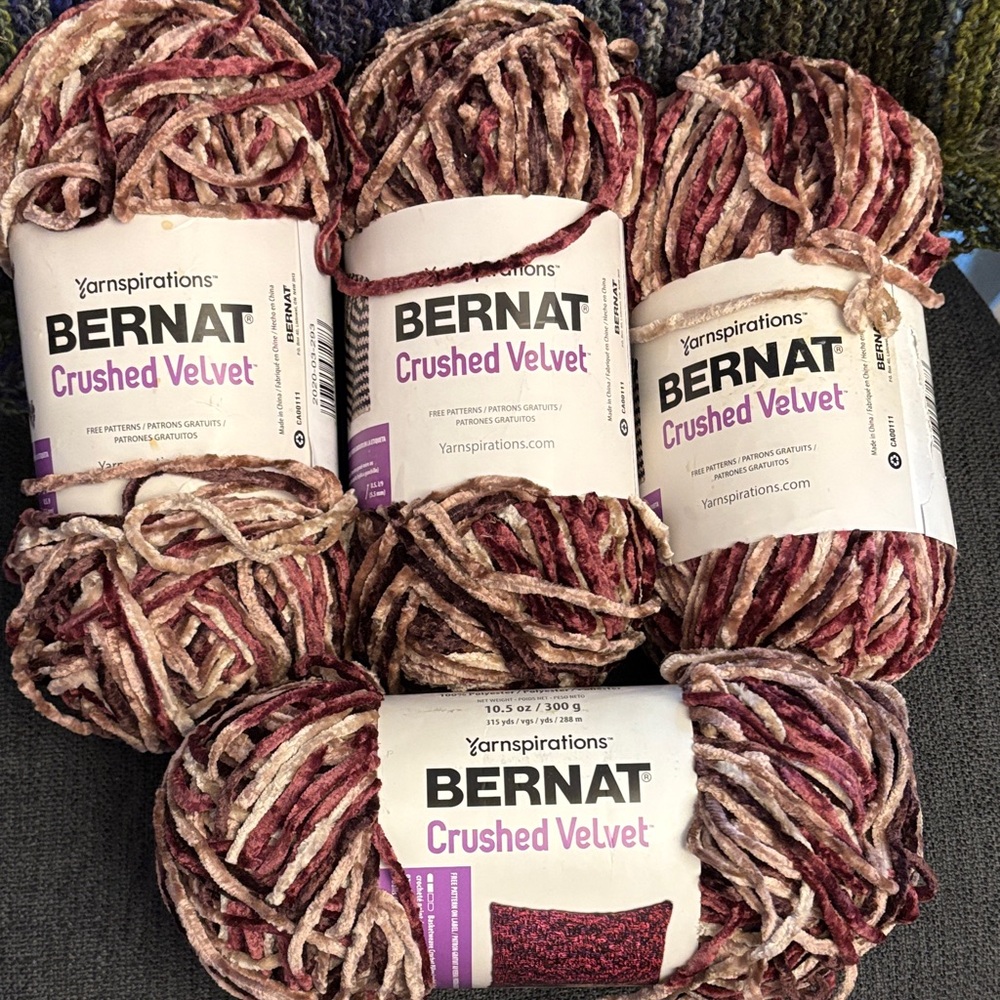 4 skeins of Bernat Crushed Velvet yarn in the colourway "Ginger Plum"